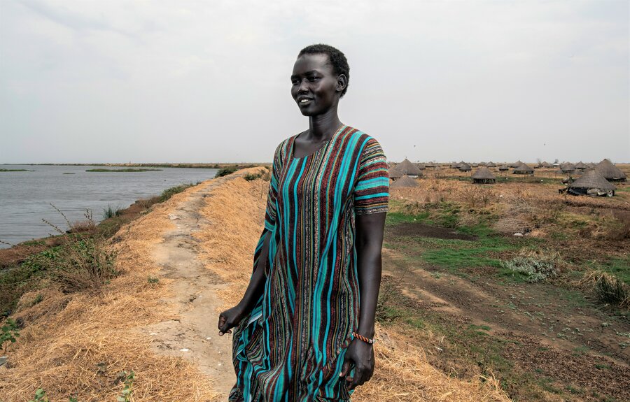Yar stands on the WFP-rehabilitated dyke that keeps Nile River waters out of South Sudan's Jalle village. Photo: WFP/Alessandro Abbonizio